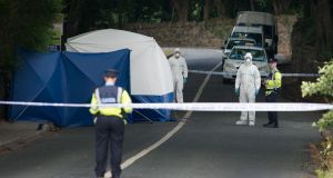 Gardaí examine the scene near Westport in Co Mayo where the bodies of two young brothers were found in a crashed car yesterday. Photograph: Michael McLaughlin. 