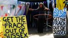 A demonstrator hula hoops among banners in the protest camp by the entrance to a site run by Cuadrilla Resources, outside the village of Balcombe in southern England. Photograph:  Luke MacGregor/Reuters