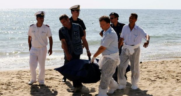 Italian police carry the body of a migrant who drowned after a shipwreck at La Playa beach in Catania in Sicily. The bodies of six migrants were recovered on the beach, and dozens of other passengers have been rescued. Photograph: Antonio Parrinello/Reuters
