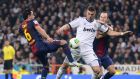 Barcelona’s midfielders Xavi Hernandez and Andres Iniesta put  pressure on  Real Madrid’s Karim Benzema. The speed with which they seek to regain possession is a key part of Barcelona’s game. Photograph: AFP/Getty Images