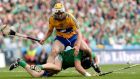 Limerick’s Stephen Walsh feels the heat from Clare’s Conor McGrath.  Photograph: Inpho/James Crombie