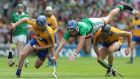 Gavin O’Mahony tries to tackle Padraic Collins but  is upended by Colin Ryan of Clare