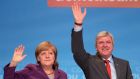 German chancellor and chairwoman of the German Christian Democrats (CDU) Angela Merkel and the prime minister of hesse Volker Bouffier (CDU) greet supporters upon her arrival at an election campaign stop  in Frankfurt, Germany yesterday. Photograph:  Thomas Lohnes/Getty Images. 