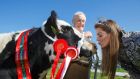 Jim Stanley looks on as Lydia Turley gives a kiss to his champion heifer at the launch of the National Ploughing Championships on the site in Ratheniska, Co Laois, yesterday. Photograph: Jeff Harvey/HR Photo