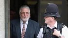 Broadcaster Dave Lee Travis (L) leaves the Old Bailey court in London, England this morning. Photograph: Oli Scarff/Getty Images