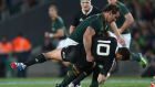 South Africa’s  Bismarck Du Plessis  hits New Zealand outhalf Dan Carter  during The Rugby Championship match  at Eden Park  in Auckland. Photograph: Sandra Mu/Getty Images