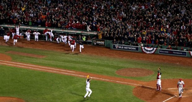 Boston Red Sox players charge from the dugout to join Koji Uehara and  David Ross  after defeating the St Louis Cardinals 6-1 in Game Six to win the  2013 World Series at Fenway Park, Boston.  Photograph: Alex Trautwig/Getty Images