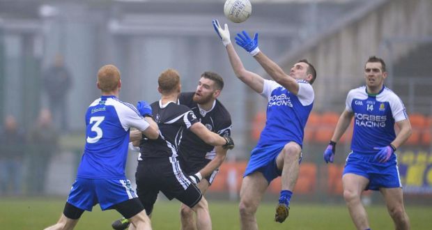 Kilcoo’s James Conway wins the ball ahead of  Ballinderry’s Paul Greenan. Photograph: Russell Pritchard/Inpho/Presseye