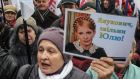 Supporters of jailed former Ukrainian prime minister and opposition leader Yulia Tymoshenko during a rally in front of the parliament building in Kiev. Photograph: Sergii Polezhaka/Reuters 