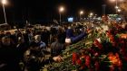 People lay flowers near a fence of Kazan airport, where a Tatarstan Airlines Boeing 737-500 airliner crashed. Photograph: Maxim Shemetov /Reuters