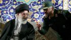 Iran’s supreme leader Ayatollah Ali Khamenei listening to Revolutionary Guards commander Mohamad Ali Jafari during a ceremony in Tehran yesterday. The ayatollah criticised France for “kneeling before the Israeli regime”. 