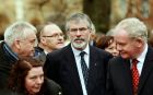 Sinn Féin President Gerry Adams (centre) and Northern Ireland Deputy First Minister Martin McGuinness (right) attend the funeral of Father Alec Reid in  the Clonard Monastery in west Belfast today. Photograph: Cathal McNaughton/Reuters.