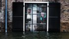  A resident inspects his house in the center of Dordrecht, The Netherlands, today after some areas in the  low-lying historic center of the city were flooded. Photograph: EPA