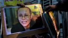 A pro-democracy protester holds a portrait of Liu Xia, wife of jailed Nobel Peace Prize laureate Liu Xiaobo, during a protest to call for the freeing of Chinese dissidents  in Hong Kong. Photograph: Tyrone Siu/Reuters