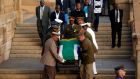 Mandla Mandela (centre back), the eldest grandson of  Nelson Mandela, watches as his flag-draped coffin is carried down steps of the Union Buildings at the end of the third and final day of lying in state in Pretoria today. Photograph: Matt Dunham/Pool/Reuters