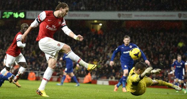 Arsenal’s Nicklas Bendtner  shoots and  past Cardiff City goalkeeper David Marshall to open the scoring in the Premier League game at the Emirates Stadium. Photograph:  Dylan Martinez/Reuters 