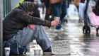  A homeless  man  begs  on  a  Dublin city street. Dublin City Council’s budget  proposes that   unding for homeless services will be cut by €6 million. Photograph: Alan Betson/The Irish Times 