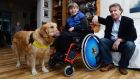 Tom Clonan with his son Eoghan (11) and Duke, Eoghan’s assistance dog, at home in Booterstown, south Dublin. Photograph: Cyril Byrne/The Irish Times 