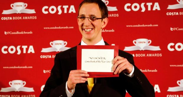 British writer Nathan Filer holds his award after winning the the 2013 Costa Book Awards for his book “The Shock of the Fall” at Quaglino’s in London yesterday. Photograph: Tal Cohen/EPA