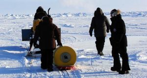 The deployment by Wood Hole staff of the buoy in the Arctic in 2011. Photograph: Steven Lambert