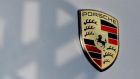A shadow of the Volkswagen logo falls across the Porsche emblem. Porsche said yesterday the claim against the board members did not include anything new