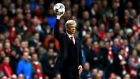Arsenal’s manager Arsene Wenger retrieves the ball during the match against Bayern Munich. Photograph: Eddie Keogh/Reuters