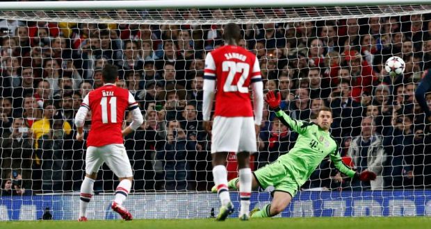Mesut Ozil’s penalty kick is saved by  Bayern Munich goalkeeper Manuel Neuer  during the Champions League match at  the Emirates Stadium. Photograph: Darren Staples/Reuters