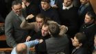 Ukrainan deputies fight during a session of parliament in Kiev today after the speaker declared a pause, delaying a debate on a possible resolution calling for President Viktor Yanukovich’s powers to be reduced. Photograph: Alex Kuzmin/Reuters. 