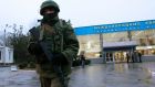 An armed man patrols at the airport in Simferopol, Crimea today. A group of armed men in military uniforms have seized the main regional airport in Simferopol, Crimea, Interfax news agency said. Photograph: David Mdzinarishvili/Reuters