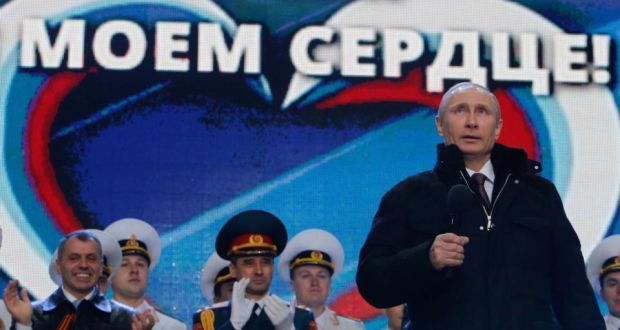 ‘When it comes to double-talk, however, there is no contest. Putin is never going to be a match for Obama at talking out of both sides of his mouth at the same time.’ Above, Vladimir Putin addresses the  audience during a rally and a concert called “We are together” to support the annexation of  Crimea, on March 18th. The words in the background read, “Crimea is in my heart”. Photograph: Maxim Shemetov/Reuters
