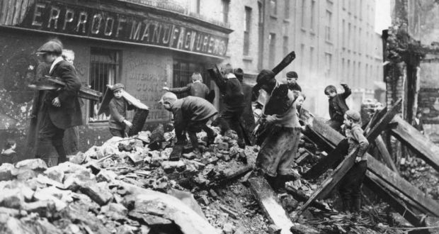 Easter 1916: children search for firewood among ruined Dublin buildings. Photograph: Central Press/Getty