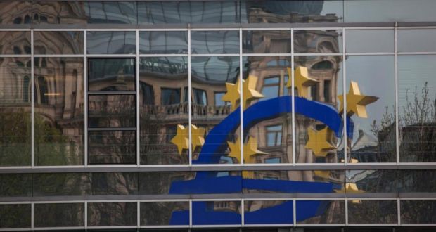 A euro sign sculpture  reflected in office windows as it stands outside the headquarters of the European Central Bank in Frankfurt. Photograph: Krisztian Bocsi/Bloomberg