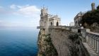 The Swallow’s Nest castle, one of Crimea’s many tourist attractions,  overlooking the Black Sea outside the  town of Yalta. Russia is encouraging its citizens to holiday in Crimea this year. Photograph: Shamil Zhumatov/Reuters