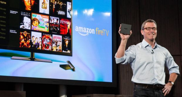 Amazon’s vice president of Kindle, Peter Larsen, displays the Amazon Fire TV, a new device that allows users to stream video, music, photos, games, through their television. Photograph: Getty