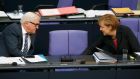 German chancellor Angela Merkel of the CDU  chats with foreign minister Frank-Walter Steinmeier of the SPD in the Bundestag on Wednesday. The two have presented a united front on a range of issues, but testing times lie ahead for the coalition partners. Photograph: Fabrizio Bensch/Reuters