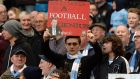 A Manchester City fan holding  up a sarcastic David Moyes sign at the Etihad Stadium last night. Photograph:  Martin Rickett/PA Wire