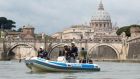 With Rome bracing itself for an influx of an estimated 1 million tourists and pilgrims, Italian Water Police patrol the Tiber river close to the Vatican City area. Photograph: Claudio Peri/EPA.