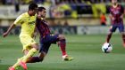 Barcelona’s Dani Alves and Villarreal’s Giovani Dos Santos fight for the ball during the match last Sunday. 