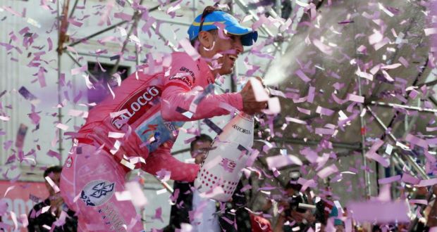 Pretty in pink: Italian cyclist Vincenzo Nibali opens a champagne bottle as he celebrates victory on the podium at the end of the 96th Giro d’Italia in  2013. Photograph: LUK BENIES/AFP/Getty Images