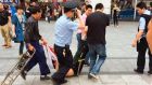 A man, whom local media say is a suspect, is detained after a knife attack at a railway station in Guangzhou, south China. Photograph: Reuters