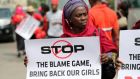 A woman carries a sign as she attends a protest demanding the release of abducted secondary school girls in the remote village of Chibok today. Photograph: Akintunde Akinleye/Reuters