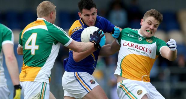 Longford’s Mark Hughes is tackled by  Niall Darby and Johnny Moloney of Offaly. Photograph: Ryan Byrne/Inpho