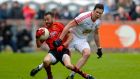 Aggression and attitude: Down’s Conor Laverty fends off Tyrone’s Sean Cavanagh during their drawn Ulster quarter-final at Celtic 	Park, Derry. Photograph: Inpho