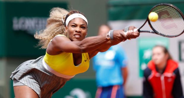  Defending champion Serena Williams goes full stretch in an attempt to return to Spain’s Garbine Muguruza during their second round tie at Roland Garros yesterday. Photograph: Yoan Valat/EPA 