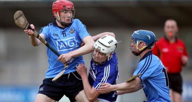 Rory Peacock of Laois is tackled by Dublin’s Kevin O’Flynn and Oisin O’Rorke at Parnell Park last night. Photograph: Ryan Byrne/Inpho.