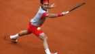 Roger Federer reaches out to return a backhand to Dmitry Tursunov of Russia during their men’s singles match at the French Open  at  Roland Garros.  Photo: Stephane Mahe/Reuters . 