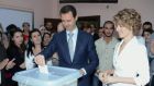 Syrian president Bashar al-Assad  and his wife Asma al-Assad cast their votes in the presidential elections at martyr Na’em Ma’asarani School in al-Malki neighborhood in Damascus yesterday. Photograph: EPA/Sana
