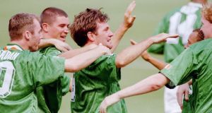 Ireland's Ray Houghton (C) is mobbed by his teammates after he scored the first goal during first half action at the World Cup match between Italy and Ireland in East Rutherford New Jersey June 19. Ireland upset Italy 1-0. ms/str-Ray Stubblebine REUTER
