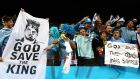 Uruguay fans salute their hero during the win over England at Arena de Sao Paulo. Photograph:   Jamie Squire/Getty Images