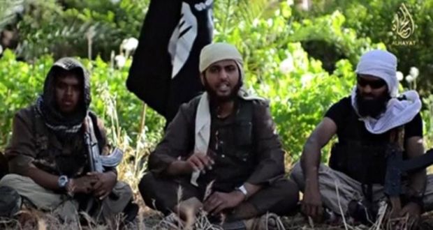An Islamist fighter, centre, identified as Abu Muthana al-Yemeni from Britain, speaks from an unknown location in an Isis video urging fellow Britons to join. Photograph: Reuters TV
